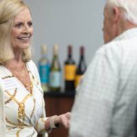 Vonnie Herrera Smiling and speaking with gentleman at event